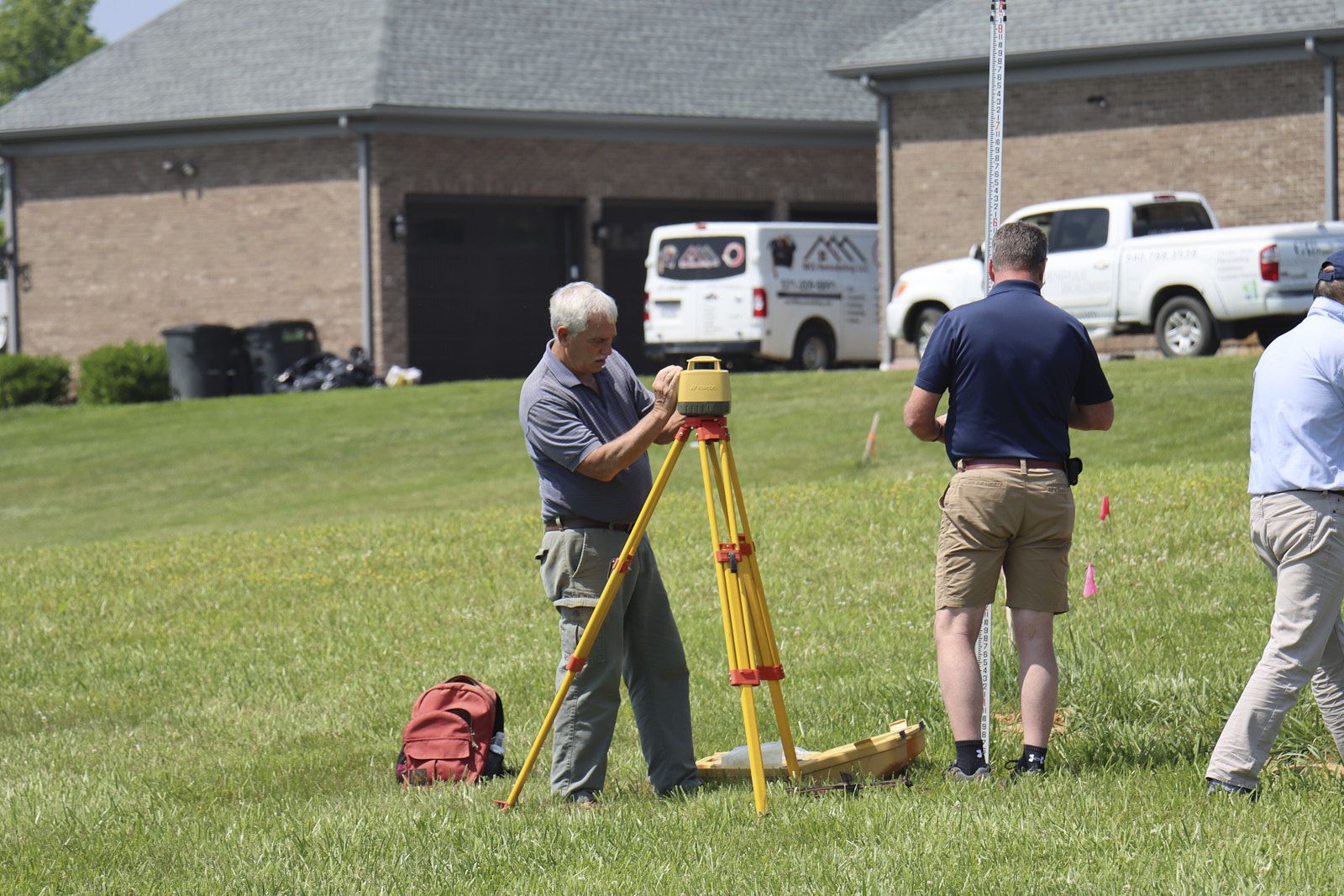 A Team Of Experts From Soils Inc In A Green Area Setting Up Their Soil Inspection Devices And Setup Around The Site