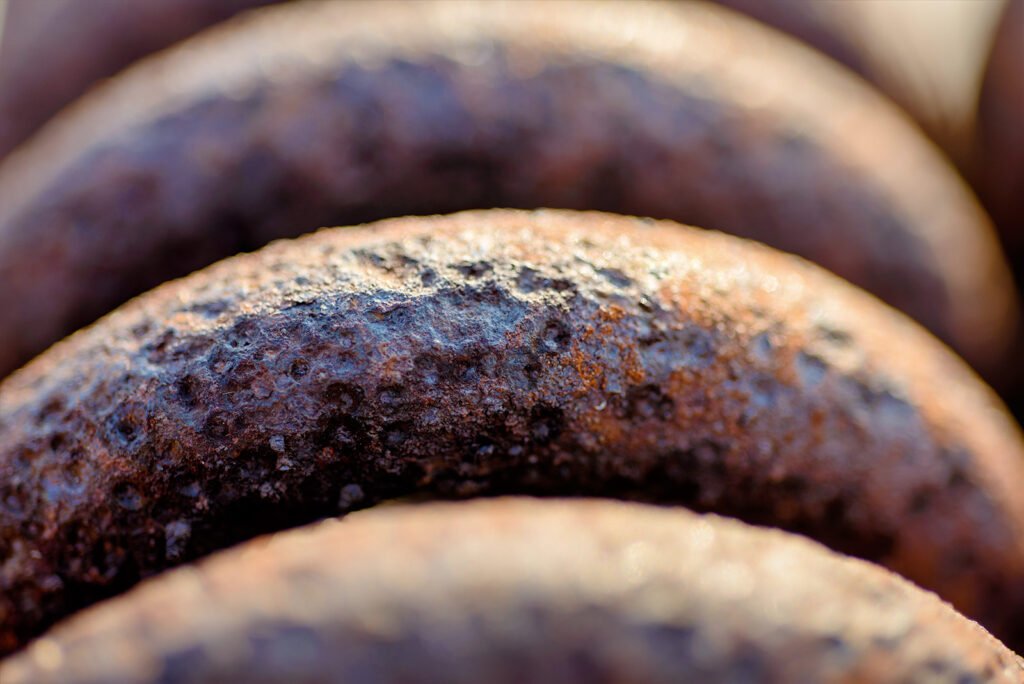 Close Up Rusty Pipes Indicating Need For Septic System Inspection And Maintenance To Prevent Corrosion And Failure